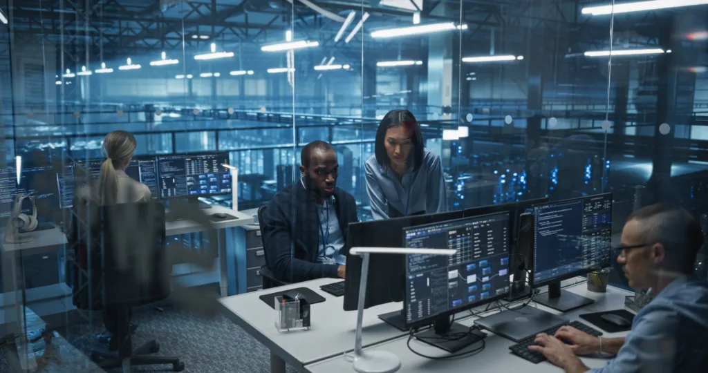 Diverse,Team,Of,Developers,Working,On,Computers,In,A,Modern