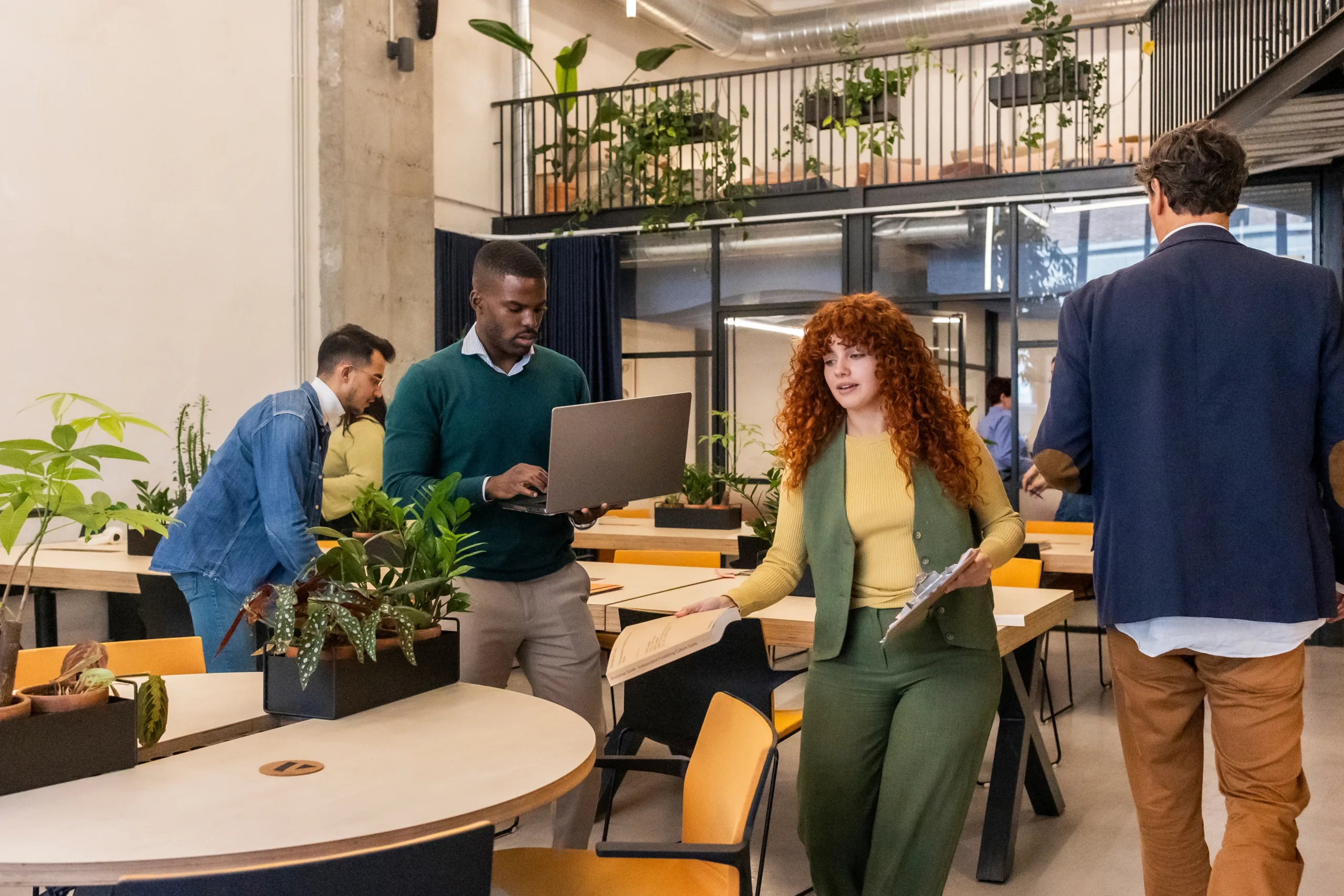 Diverse,Business,Professionals,Walking,And,Working,With,Laptops,And,Documents