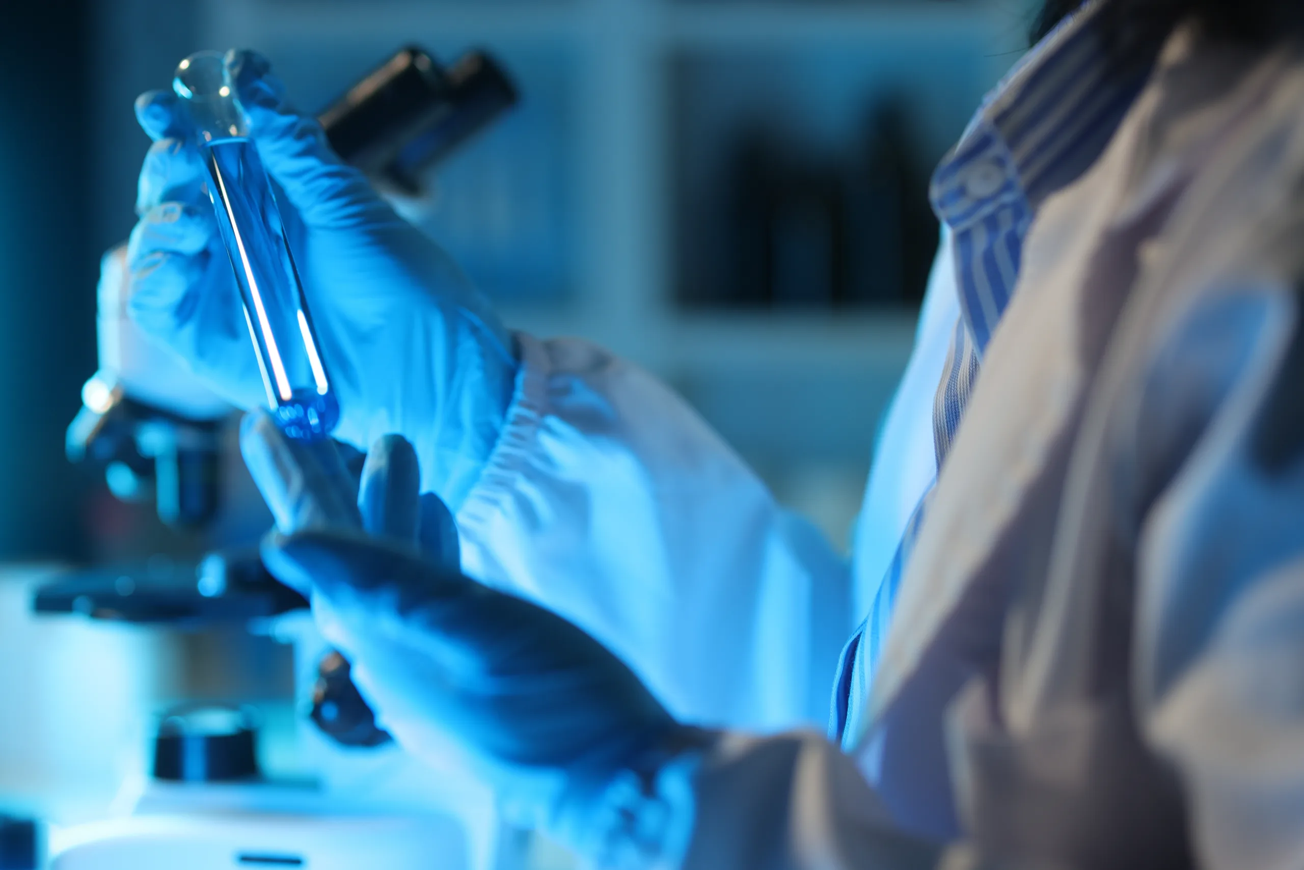 Medical,Scientist,Analyzing,Test,Tube,With,Blue,Liquid,In,Laboratory.