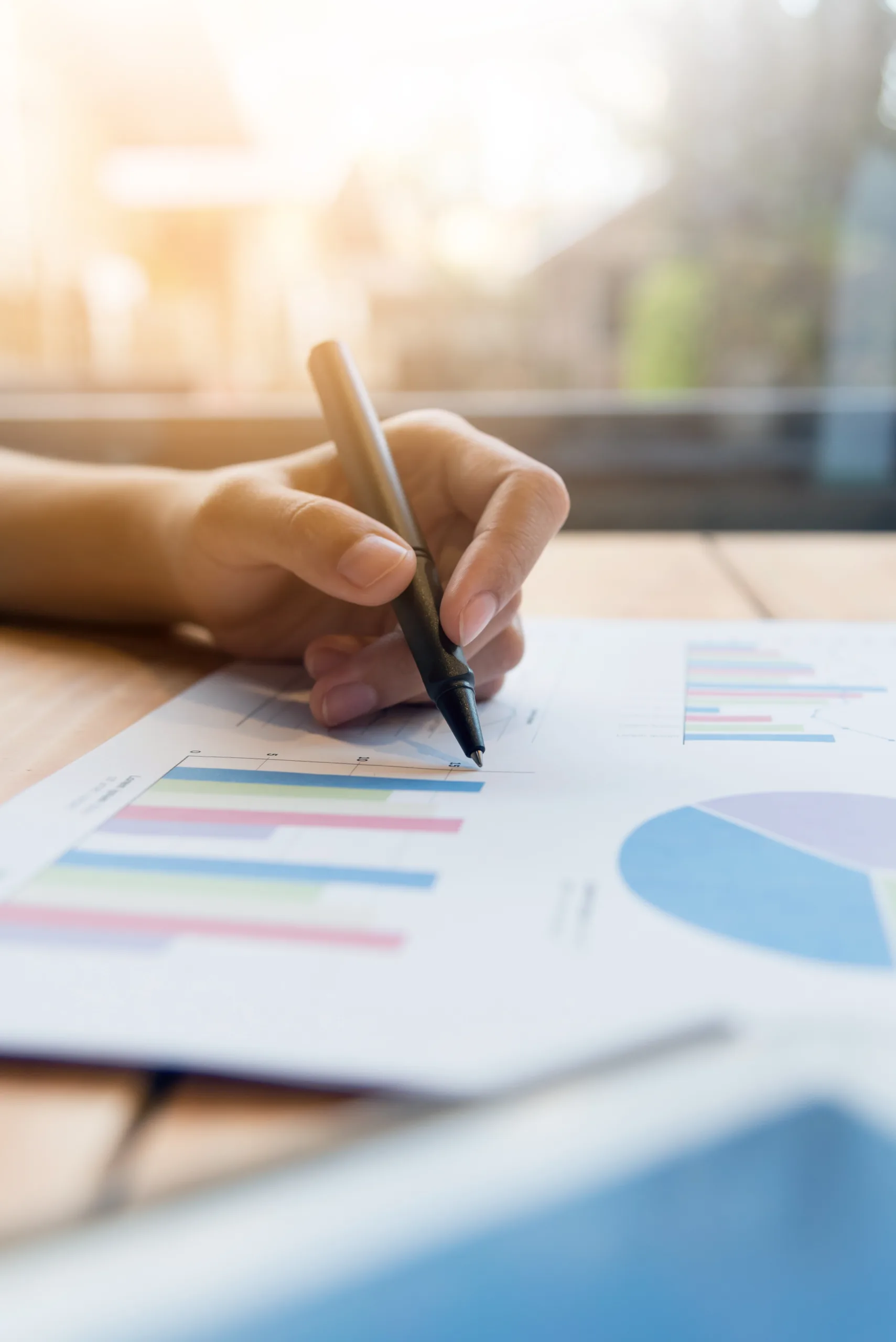 Close,Up,Of,Business,Woman,Hands,Writing,On,Graphs,And